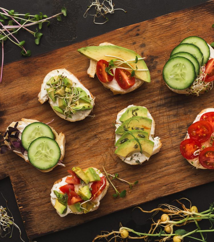 Vegetarian wholegrain sandwiches with micro greens. Vegan party food table with organic vegetables canapes. Healthy lifestyle and eating right concept